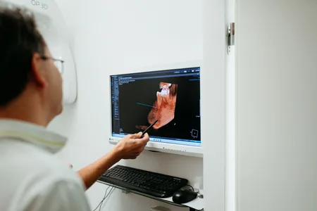 Zahnarzt bespricht einen 3D-Scan am Bildschirm